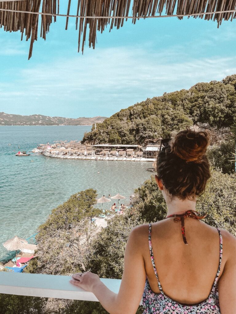 Traveler enjoying the beaches of Ksamil, showing how to get around in Albania with ease and without stress.