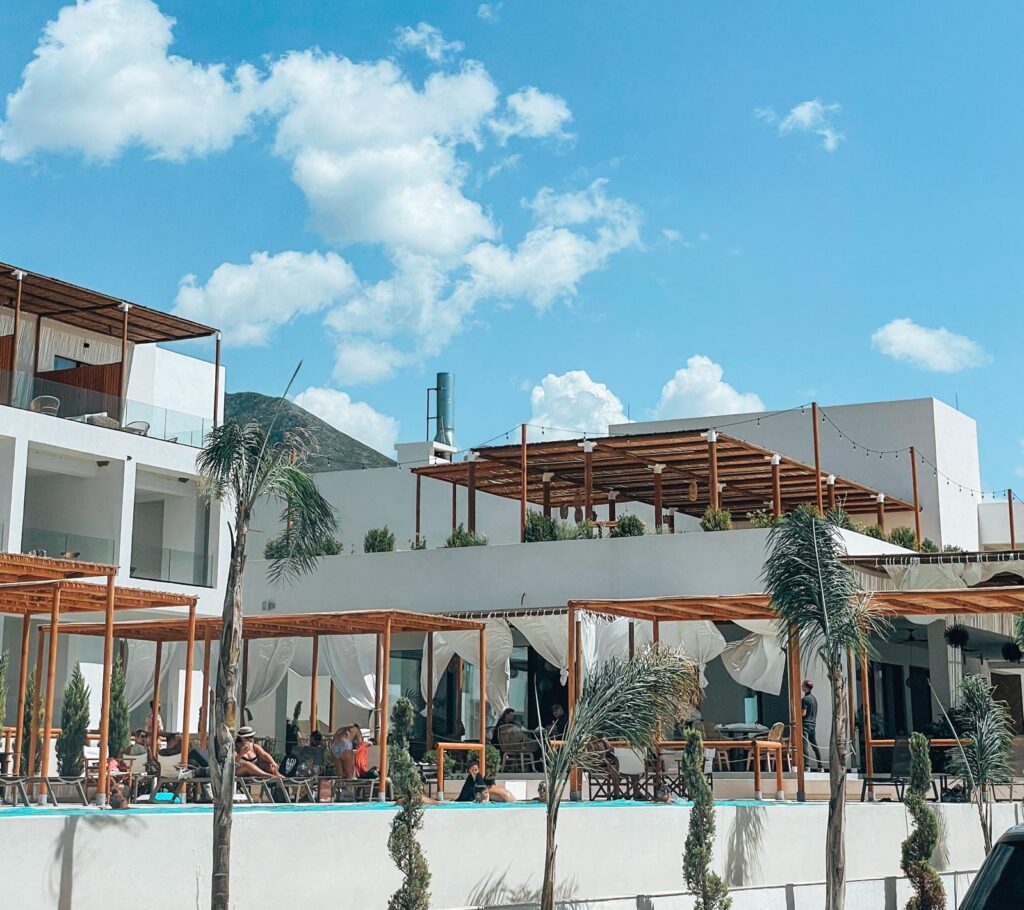 A hotel in Valona with a modern exterior and balconies overlooking the city. The image helps show accommodation options and whether you need lek in Albania or can pay by card in coastal cities.