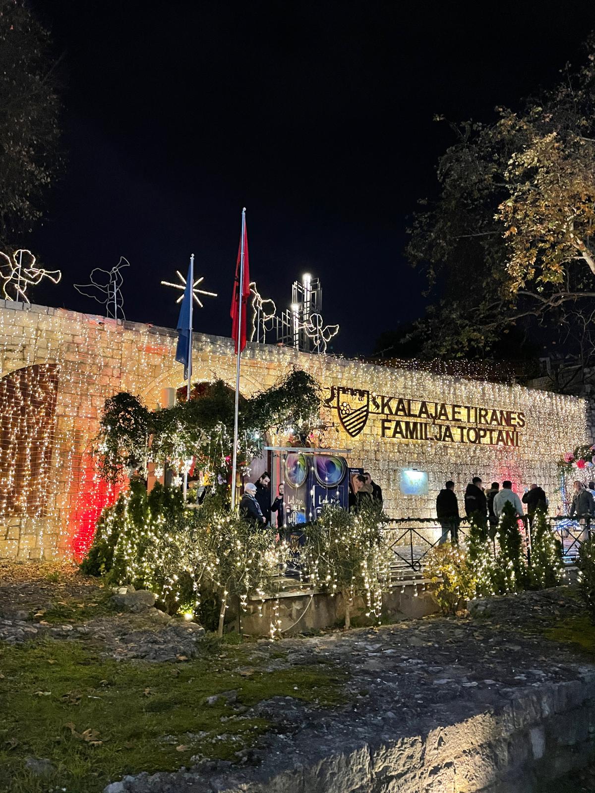Stone walls and historic buildings inside Tirana Castle in the heart of Albaniaโs capital with cafes and shops lining the walkway. The image shows a well maintained public space that feels lively and welcoming, helping illustrate whether Albania is safe for solo female travelers.