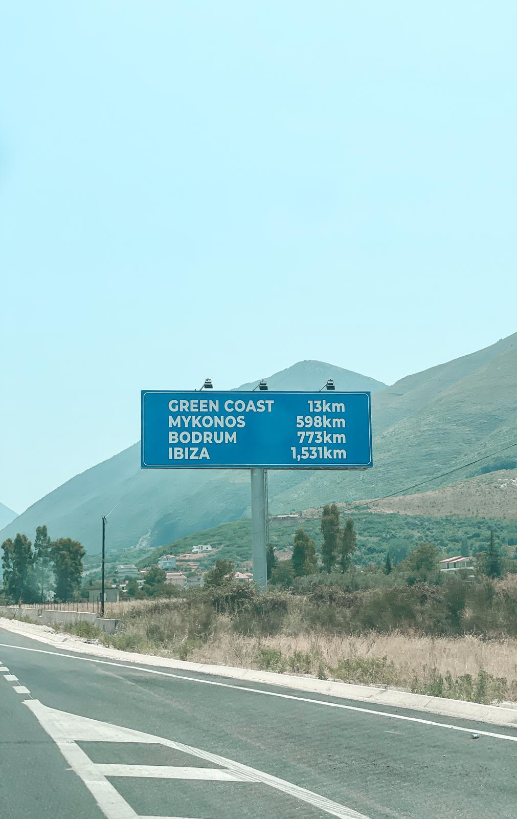 Winding coastal road between Vlora and Saranda, between rugged hills, capturing the scenic journey travelers take after arriving via the Corfu to Saranda ferry.