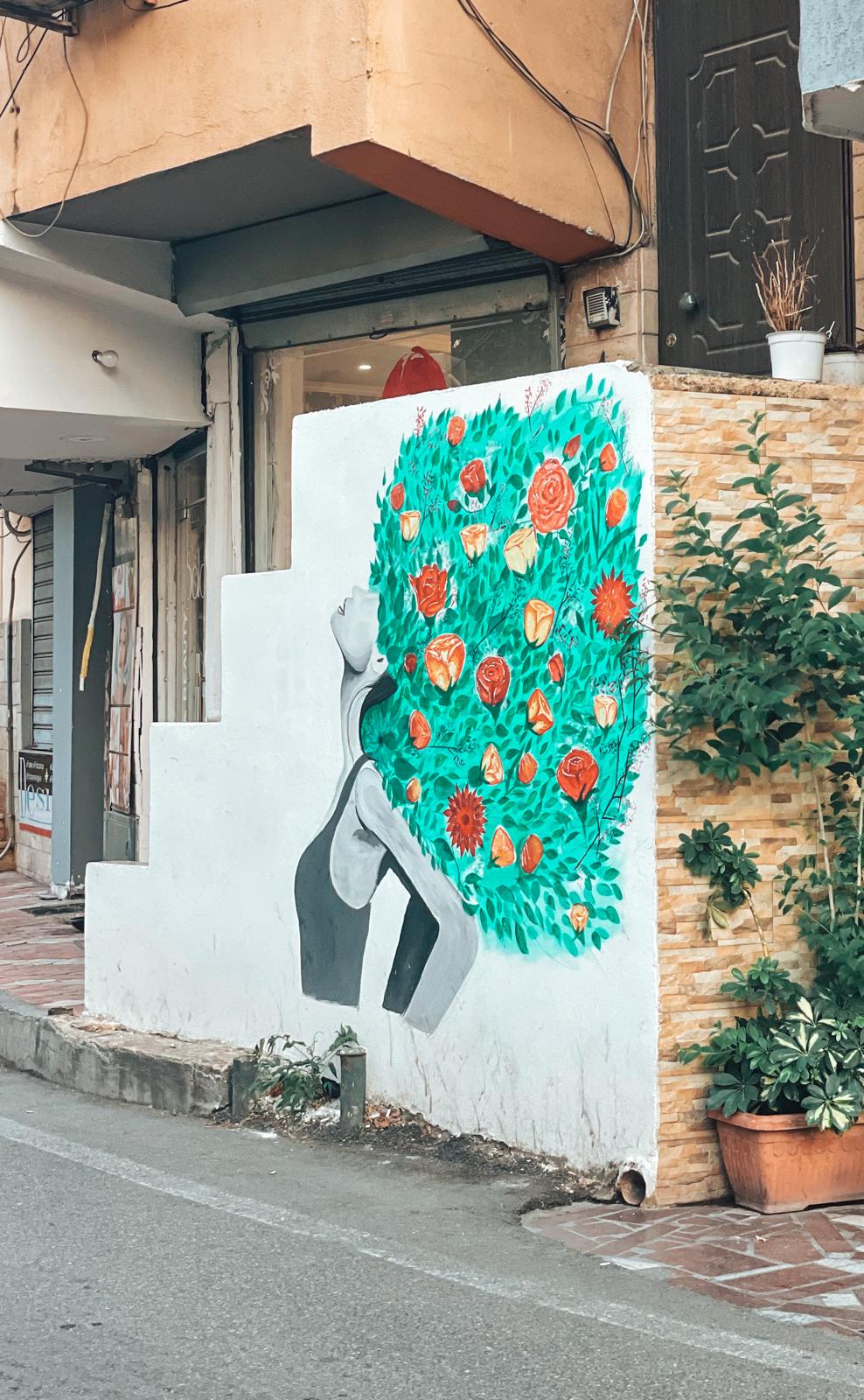 Colorful mural on a building in Tirana featuring bold shapes and vibrant street art, reflecting the creative energy highlighted in an ultimate Albania Itinarary.