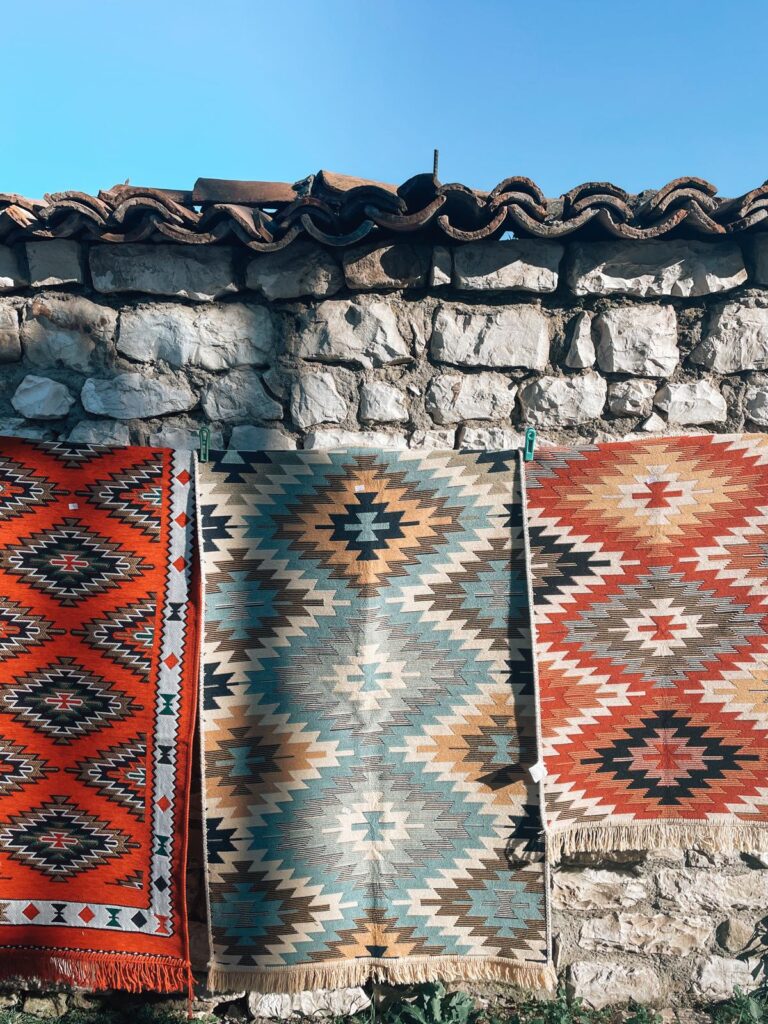 Artisan in Berat creating traditional Albanian handwork with intricate patterns and detailed craftsmanship visible up close. The cultural scene highlights local heritage experiences during a 7 days in Albania itinerary.