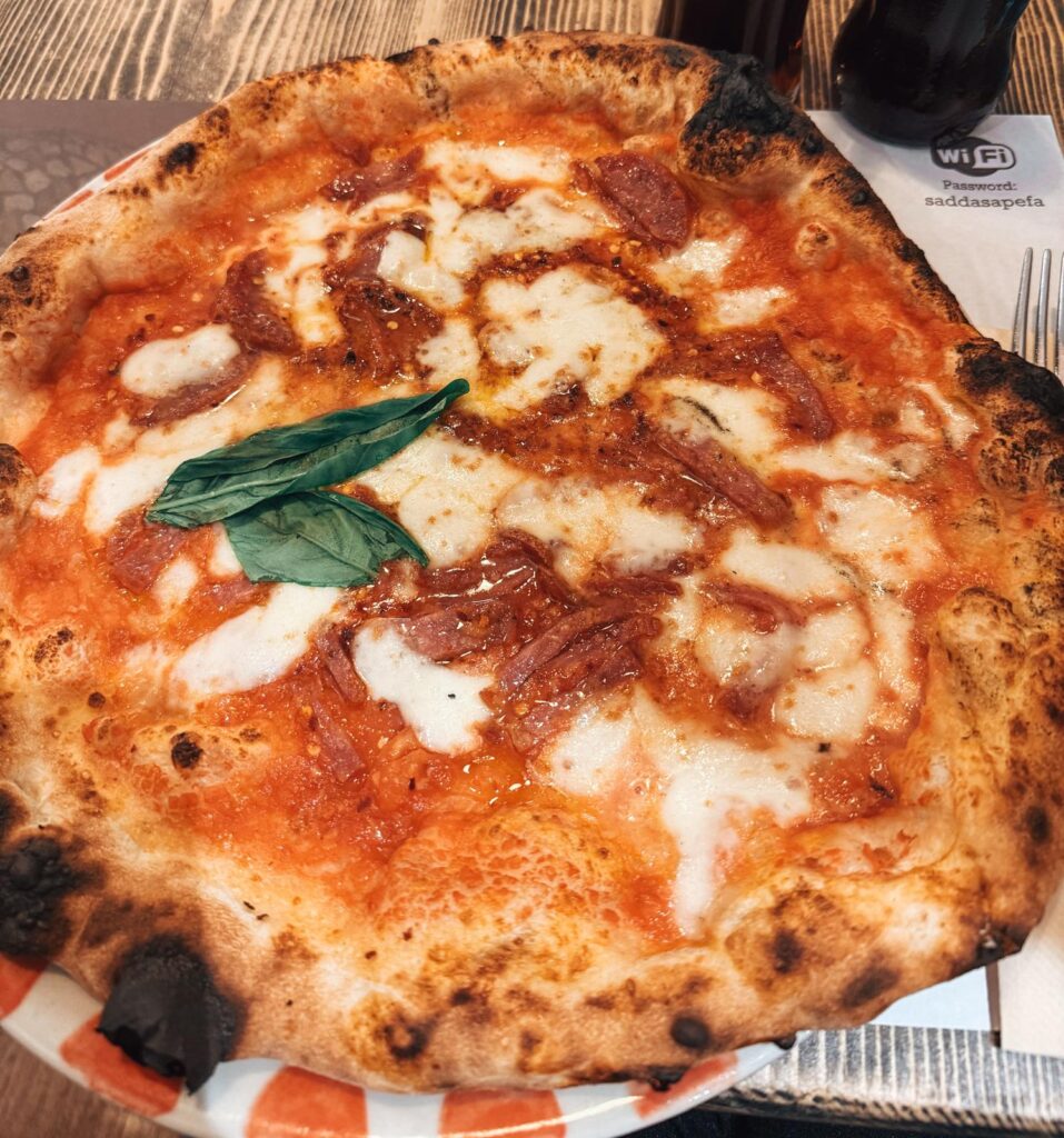 Wood fired pizza with a crisp crust and fresh toppings served at Pizarte in Tirana. The dish showcases the casual dining experience and quality you can expect from the best restaurants in Tirana.