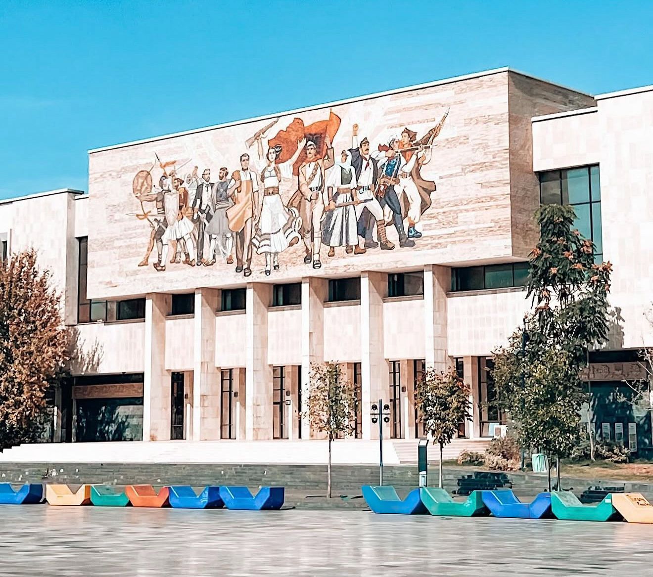 The National History Museum in Tirana seen from Skanderbeg Square with its large mosaic facade and open plaza in front. This landmark represents one of the main museums in Tirana and a central cultural stop in the city.