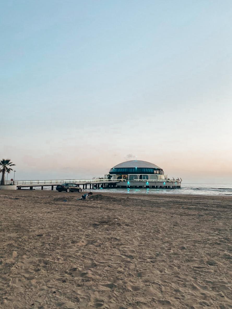 Durrës Beach in Albania with a wide sandy shoreline stretching along the Adriatic Sea and rows of umbrellas and sunbeds near the water. The lively seaside atmosphere and long accessible coast make it one of the best beaches in Albania for families and casual beachgoers.