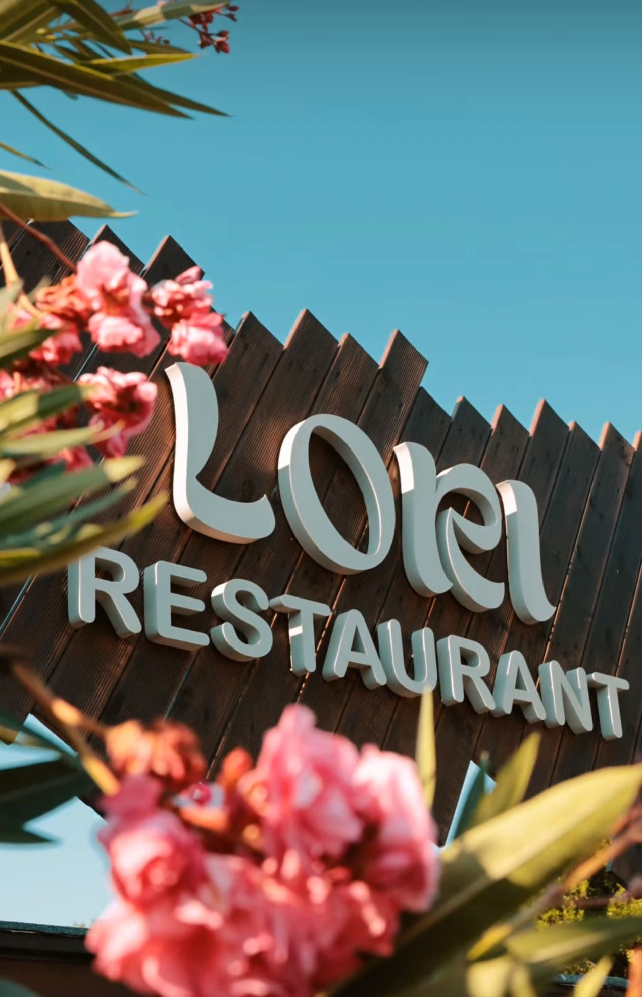 Exterior view of Lori Beach Bar with modern beachfront design, shaded seating areas, and coastal decor overlooking the sea in Albania. The stylish open-air setting captures the laid-back energy of beach bars and clubs in Albania.