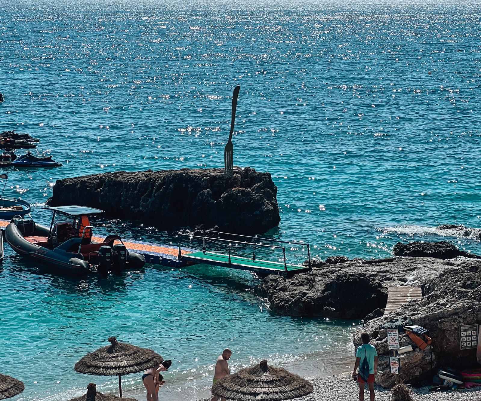 Luciano Restaurant in Dhermi sits directly on the seafront, with outdoor seating that faces the Ionian Sea and a relaxed coastal dining atmosphere. The setting highlights the beachside charm often compared in the drymades vs Dhermi area, blending ocean views with a casual restaurant vibe.