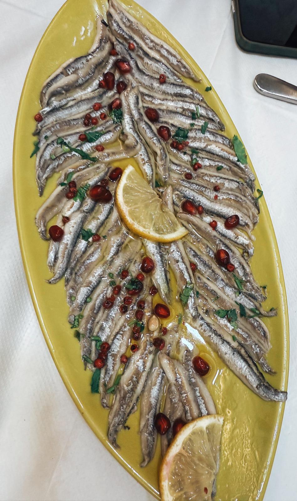 Fresh local seafood and traditional Albanian dishes served at a seaside restaurant in Saranda. The meal reflects the coastal flavors visitors can enjoy after a day by the water.