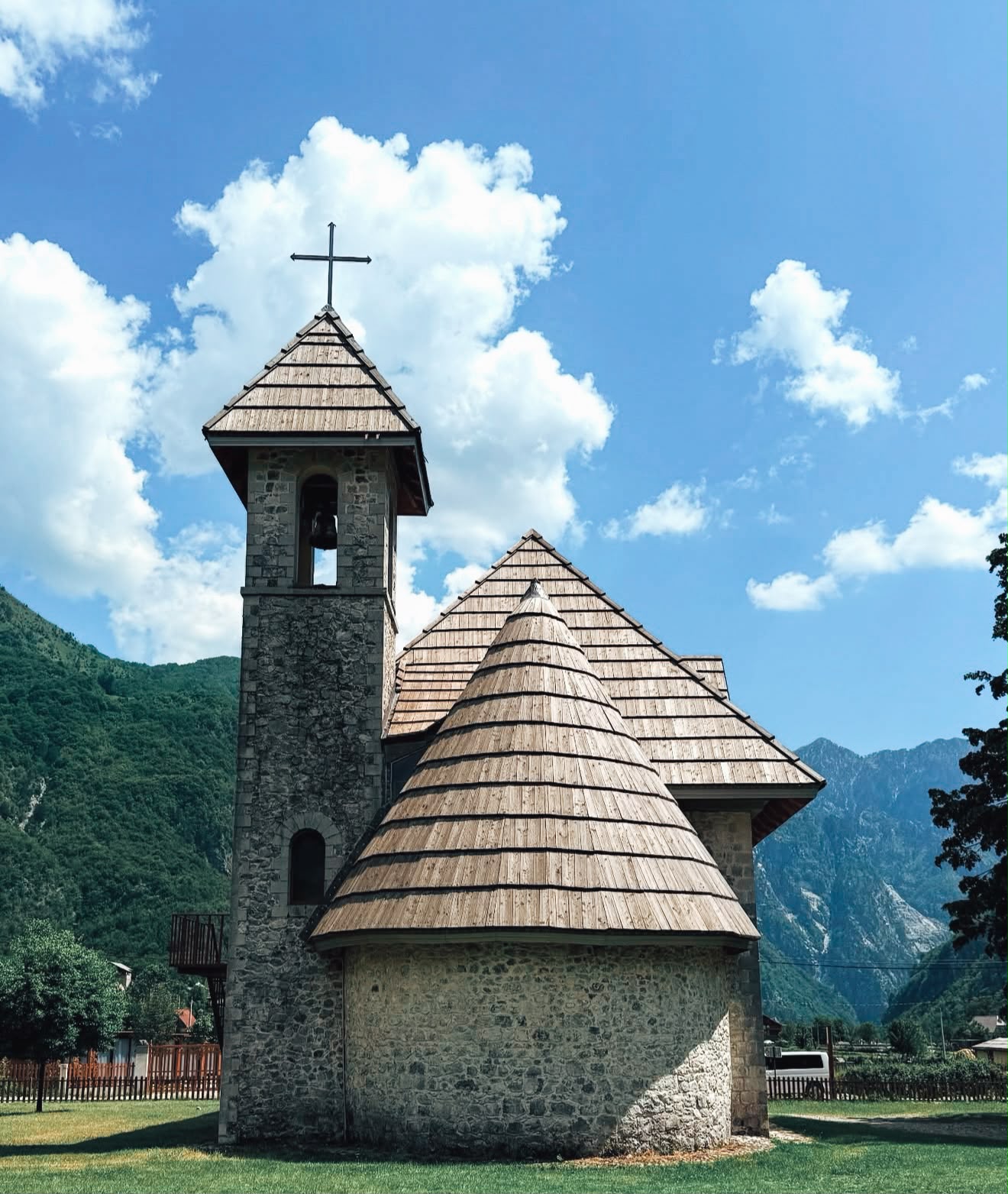 Thethi Church sits in a wide alpine meadow surrounded by the dramatic peaks of the Albanian Alps, with its white stone walls and bell tower standing out against the mountain landscape. This historic church is one of the most recognizable landmarks in Theth and a popular stop when exploring the region.