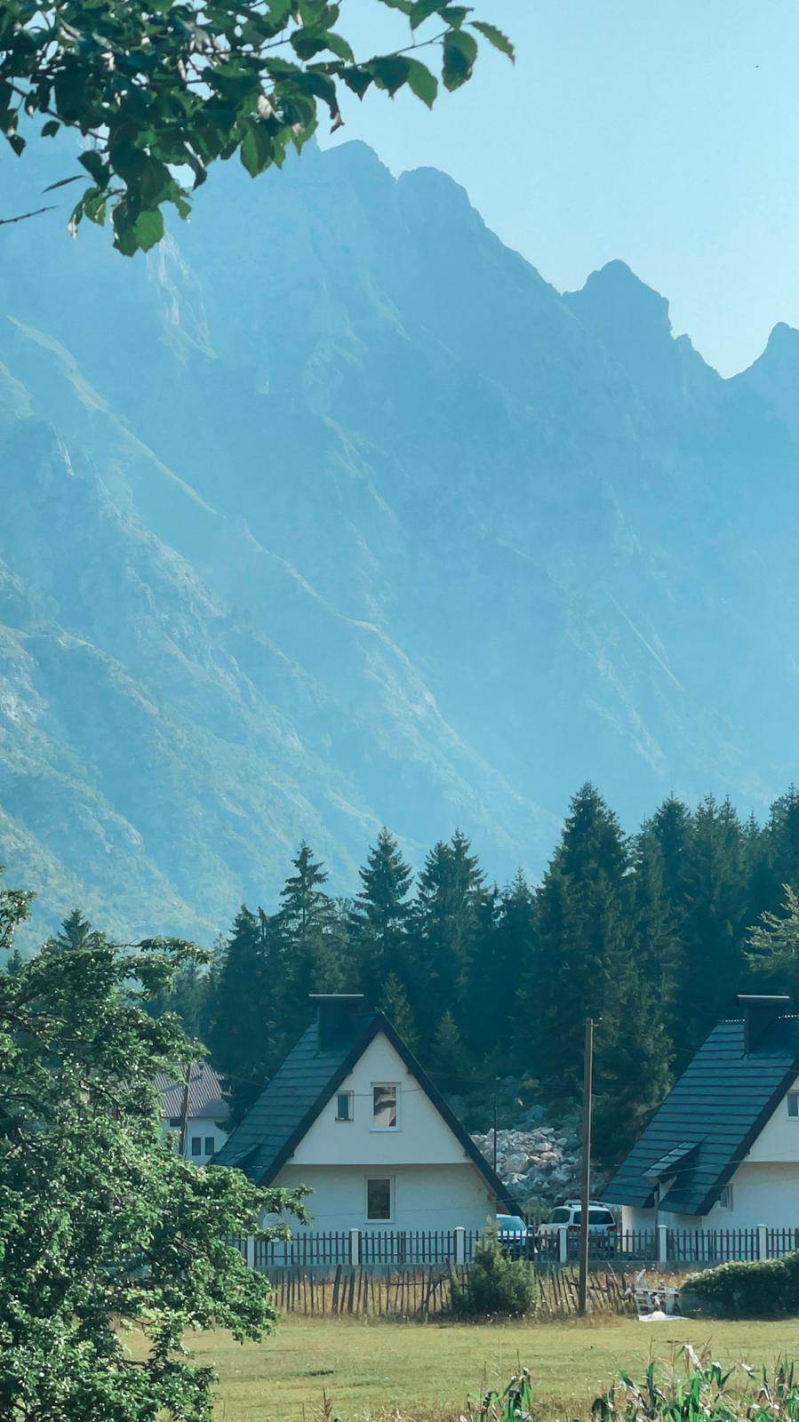 Traditional guesthouses sit among the green valleys and towering mountains of Valbona, offering a peaceful place for travelers to stay. These mountain lodges show how visitors can experience Valbona’s scenery and local hospitality without needing to hike.