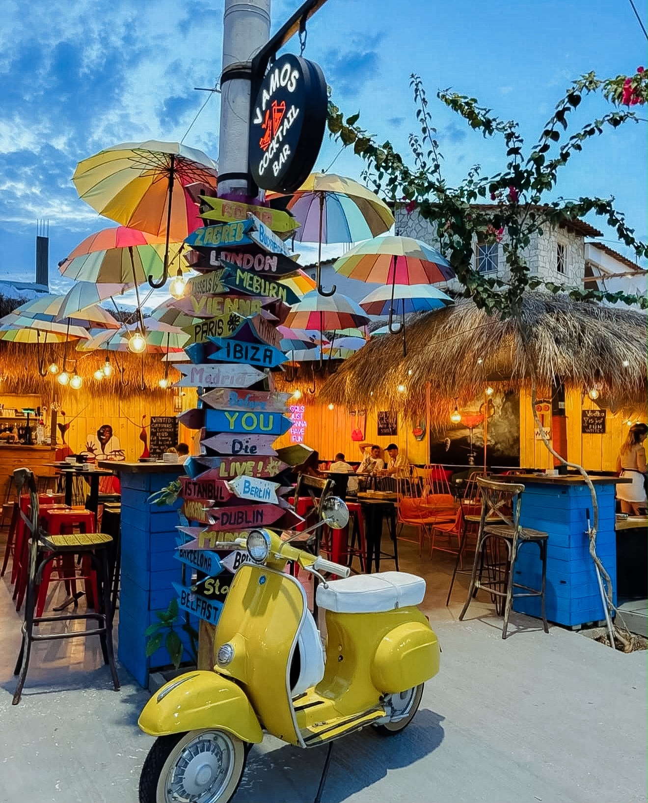 Restaurant exterior in Ksamil with outdoor seating area near the street and a relaxed coastal atmosphere. The setting reflects the kind of dining spots visitors can find near Saranda, especially when exploring where to stay in Saranda and nearby areas.