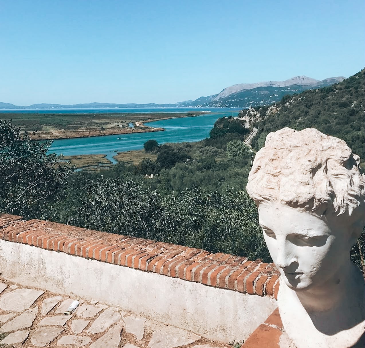 Scenic view of natural landscape inside Butrint National Park, showing lush greenery and a calm, open environment. The scene highlights the park’s natural surroundings and peaceful atmosphere with vegetation stretching into the distance.